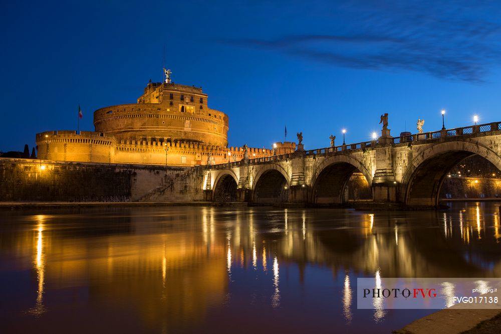 Castel Sant'Angelo and the bridge Sant'Angelo illuminated with the blue sky before the dawn