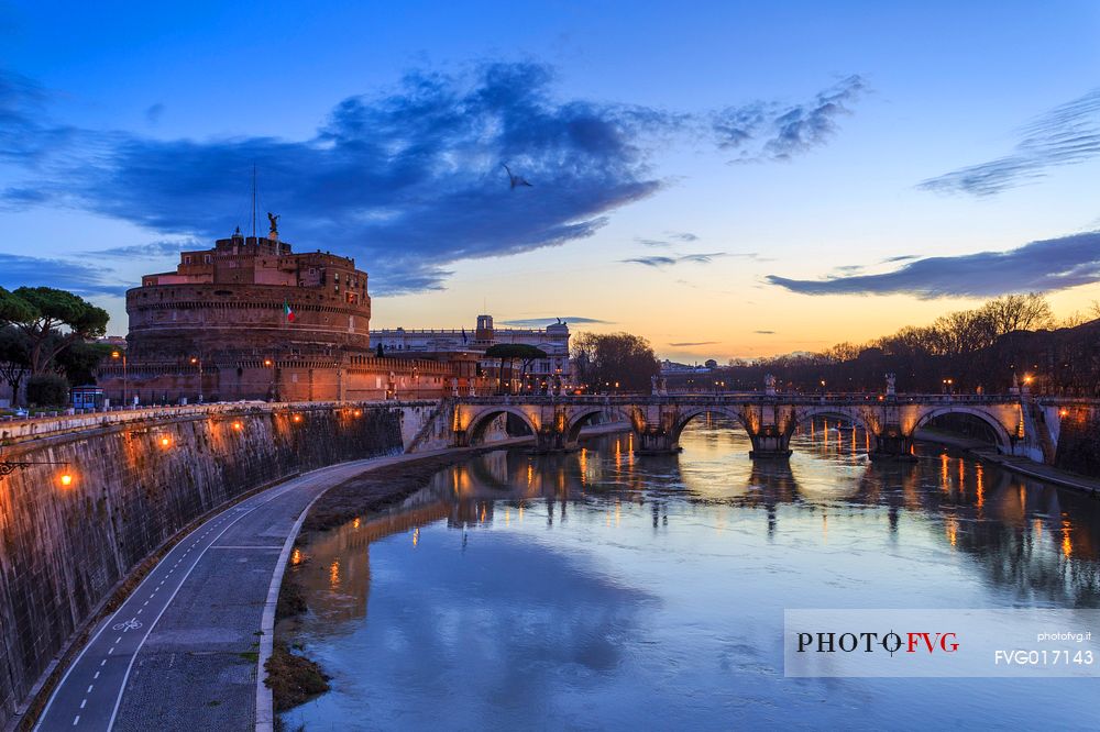 Castel Sant'Angelo and the bridge Sant'Angelo illuminated with the blue sky before the dawn