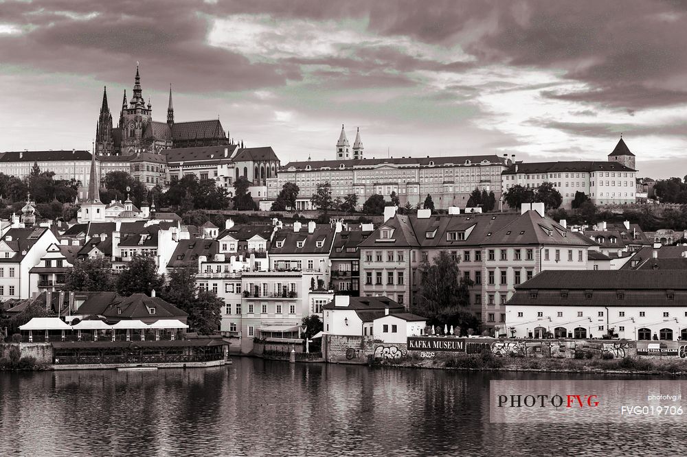 Prague, view across Vltava River and Charles Bridge towards Hradcany Castle and St. Vitus Cathedral at dusk
