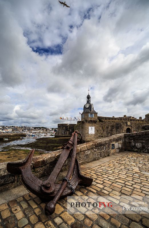 Clock Tower and Anchor on the Bridge leading to the Old Town, Ville Close, in Concarneauan ancient fortified town on the coast of French Cornwall, Brittany, France, Europe                                                         