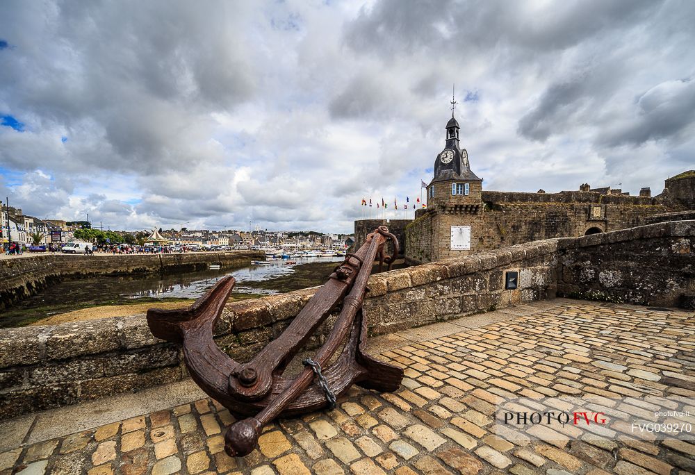 Clock Tower and Anchor on the Bridge leading to the Old Town, Ville Close, in Concarneauan ancient fortified town on the coast of French Cornwall, Brittany, France, Europe                                                         