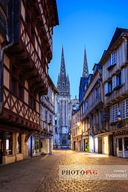 View of the bell tower of Saint Corentin cathedral and the old house of Quimper, capital of French Cornwall, Britanny, France, Europe