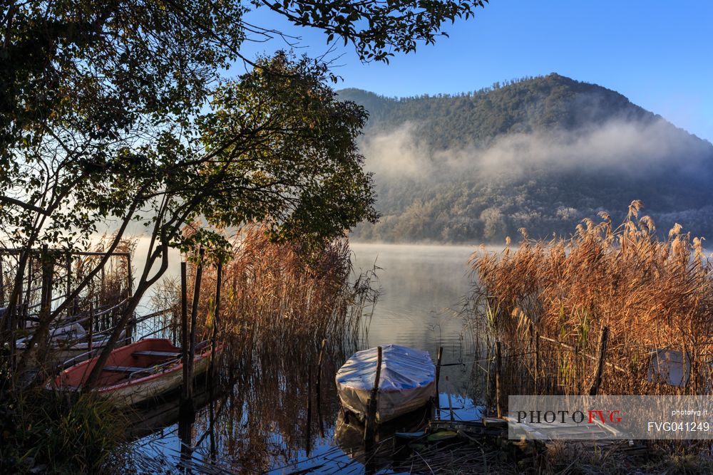 The Piediluco lake on an autumn morning with the fog rising from the water, Umbria, Italy, Europe