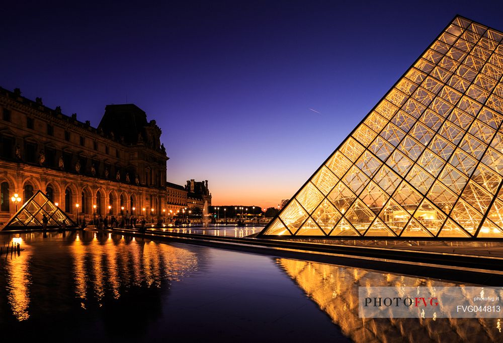 Sunset lights at the Louvre square with the glass pyramid, Paris, France, Europe