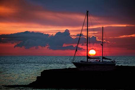 Wonderful sunset in Ponza with a sail boat silhouette and sun