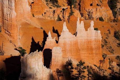 Rocks sculpted by wind and rain in Bryce Canyon , called hoodoos , are believed by the native, to be the ancient petrified inhabitants of this country.