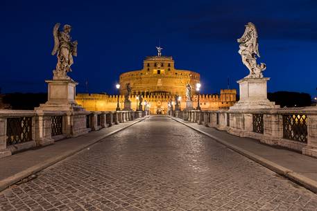 Castel Sant'Angelo and the bridge Sant'Angelo illuminated with the blue sky before the dawn Castel Sant'Angelo and the bridge Sant'Angelo illuminated with the blue sky before the dawn