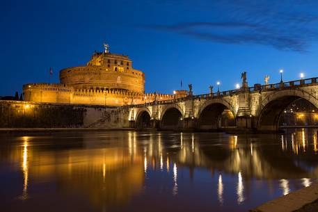 Castel Sant'Angelo and the bridge Sant'Angelo illuminated with the blue sky before the dawn Castel Sant'Angelo and the bridge Sant'Angelo illuminated with the blue sky before the dawn