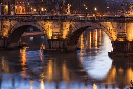The bridge Sant'Angelo illuminated with reflections on the Tevere's water The bridge Sant'Angelo illuminated with reflections on the Tevere's water