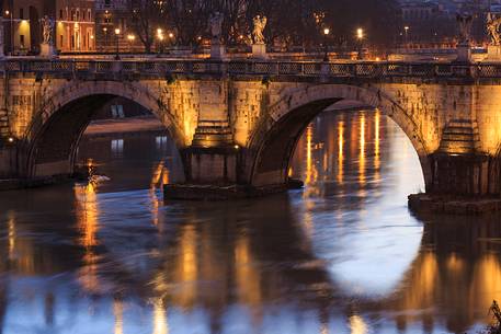 The bridge Sant'Angelo illuminated with reflections on the Tevere's water