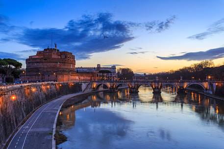 Castel Sant'Angelo and the bridge Sant'Angelo illuminated with the blue sky before the dawn Castel Sant'Angelo and the bridge Sant'Angelo illuminated with the blue sky before the dawn