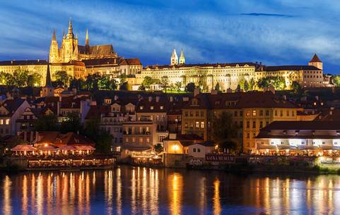 Prague, night view across Vltava River and Charles Bridge towards Hradcany Castle and St. Vitus Cathedral