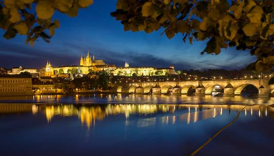 Prague, night view across Vltava River and Charles Bridge towards Hradcany Castle and St. Vitus Cathedral