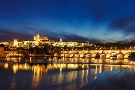 Prague, night view across Vltava River and Charles Bridge towards Hradcany Castle and St. Vitus Cathedral
