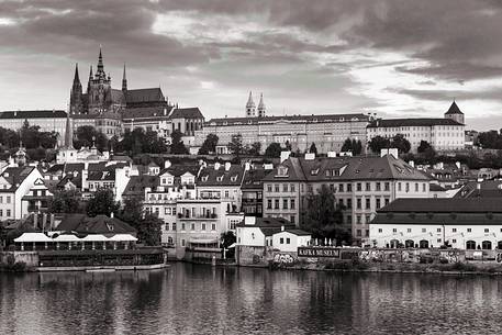 Prague, view across Vltava River and Charles Bridge towards Hradcany Castle and St. Vitus Cathedral at dusk
