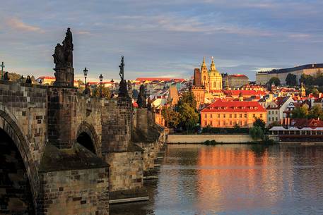 Prague, view across Vltava River and Charles Bridge at dusk
