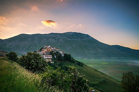 Castelluccio di Norcia and the Monte Vettore in the background at dawn. Monti Sibillini national park, Umbria, Italy, Europe. Castelluccio di Norcia and the Monte Vettore in the background at dawn. Monti Sibillini national park, Umbria, Italy, Europe.