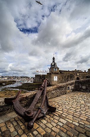 Clock Tower and Anchor on the Bridge leading to the Old Town, Ville Close, in Concarneauan ancient fortified town on the coast of French Cornwall, Brittany, France, Europe                                                         