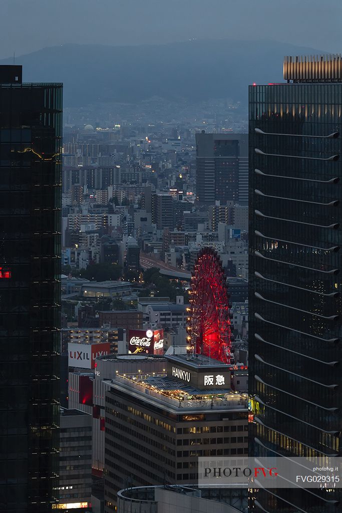 View of the worlds first Ferris wheel directly connected to a building and resistant to earthquake in the central part of Osaka, Japan