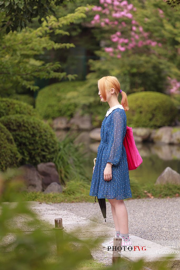 Young girl in the famous To-ji temple gardens, in Minami-ku. Unesco World Heritage Site, Kyoto, Japan
