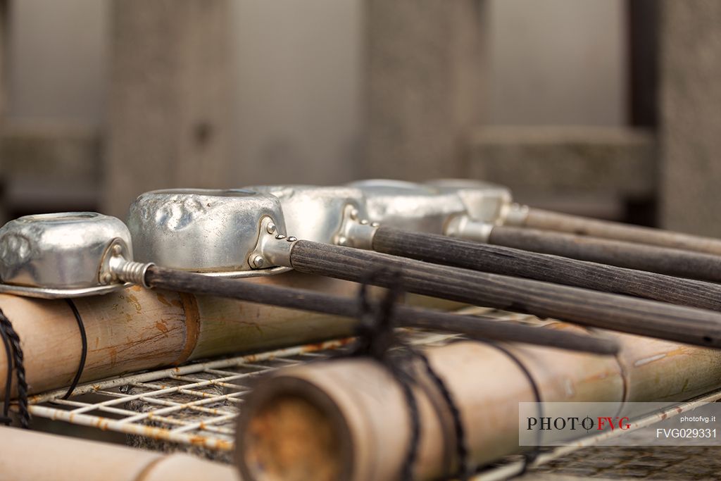 Hand water bowls for purification in the To-ji buddhist Temple, Kyoto, Japan