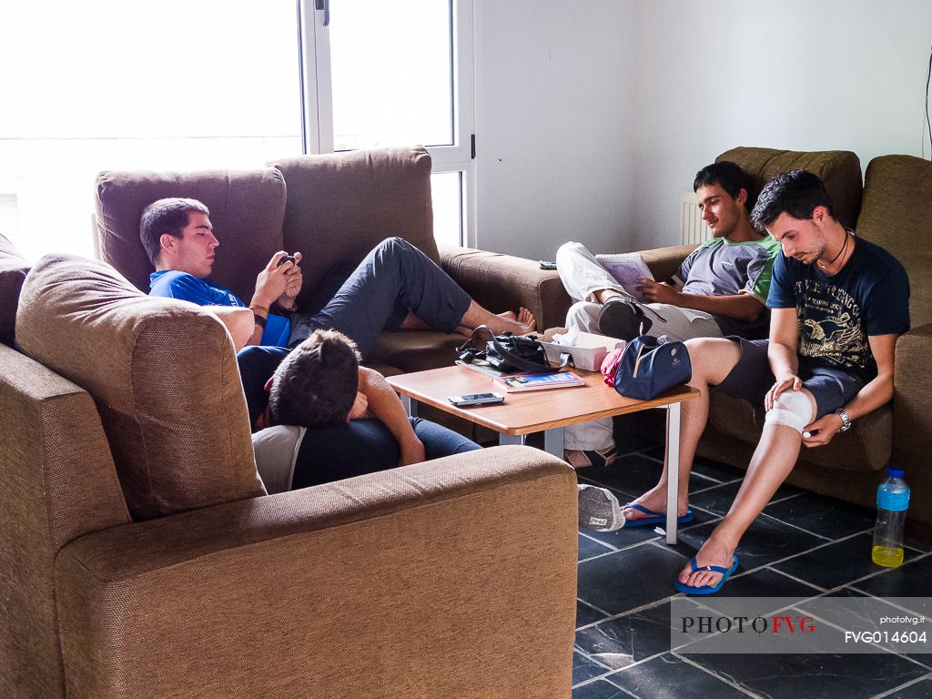 Some pilgrims rest in the the sitting room of an hostel