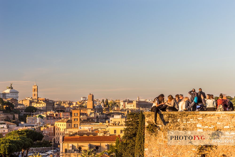 Some people watch the sunset from the terrace of the Garden of Oranges.