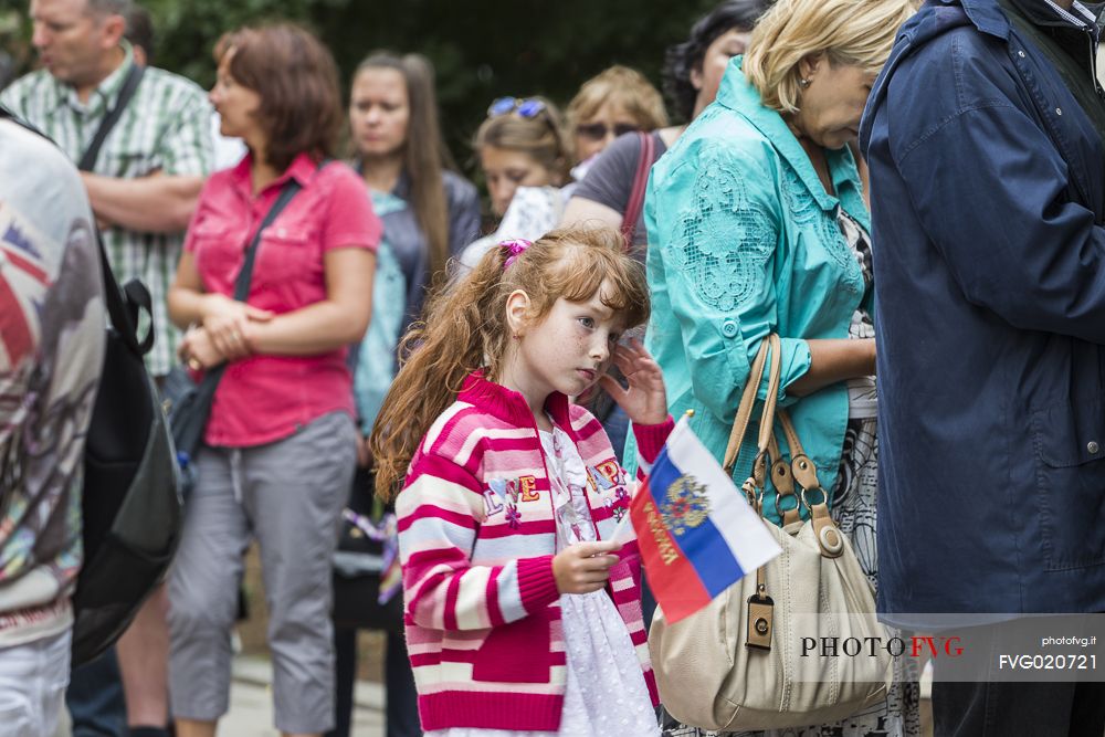A child in queue is waiting to pay the ticket to go inside Saint Basil's Cathedral in the Red Square in Moscow, Russia