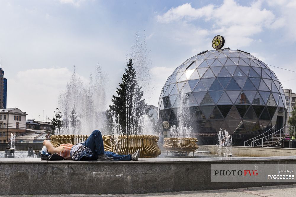 A woman resting in front of the Travelers's Coffee of Novosibirsk.