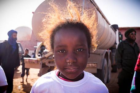 A young girl at the end of a short run competition organized by us for local children