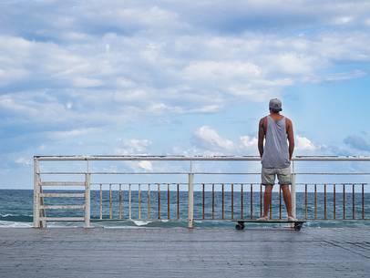 A young guy look at the ocean