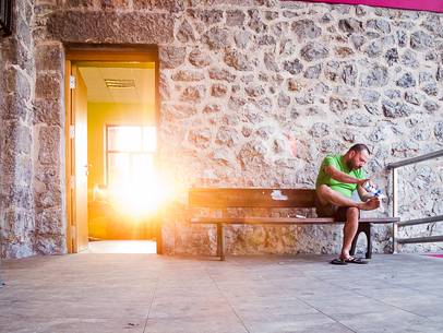 A pilgrim takes care of his feet before starting walking