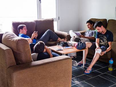 Some pilgrims rest in the the sitting room of an hostel