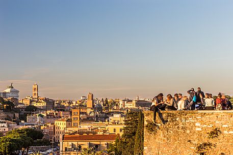 Some people watch the sunset from the terrace of the Garden of Oranges.