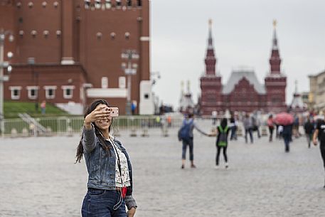 A young girl taking a selfie in the Red Square in Moscow, Russia