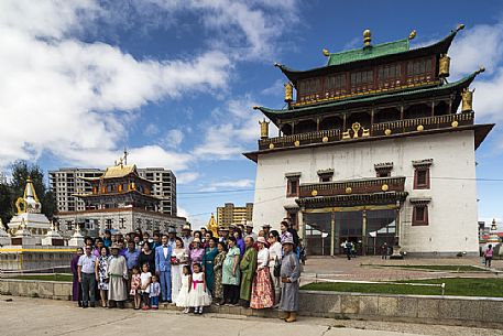 Some people are taking a group photo during a mongolian wedding in front of the Gandantegchinlen Khiid monastery, Mongolia