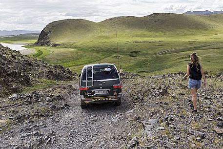 Car going downhill in the mongolian steppe, Mongolia