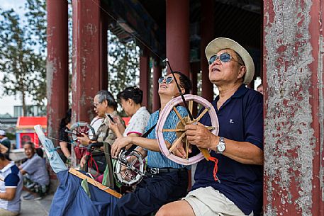 A man flying the kite inside the Summer Palace, Beijing, Peking A man flying the kite inside the Summer Palace, Beijing, Peking