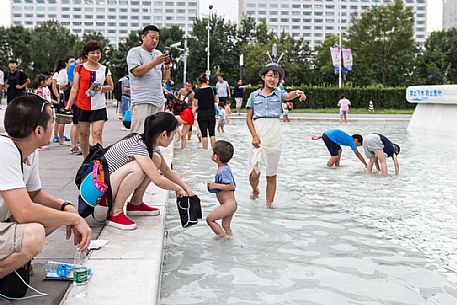 Children playing outside the Beijing National Aquatics Center (called Water Cube) inside the Olympic Green, the olympic park built for 2008 Summer Olympics Children playing outside the Beijing National Aquatics Center (called Water Cube) inside the Olympic Green, the olympic park built for 2008 Summer Olympics