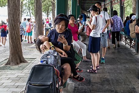 People resting below the Long Corridor inside the Summer Palace in Beijing People resting below the Long Corridor inside the Summer Palace in Beijing