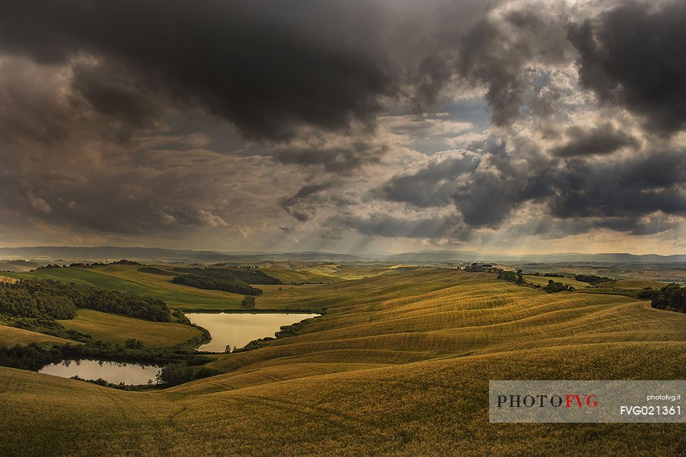 Light over the lake in the Crete Senesi landscape, Tuscany, Italy