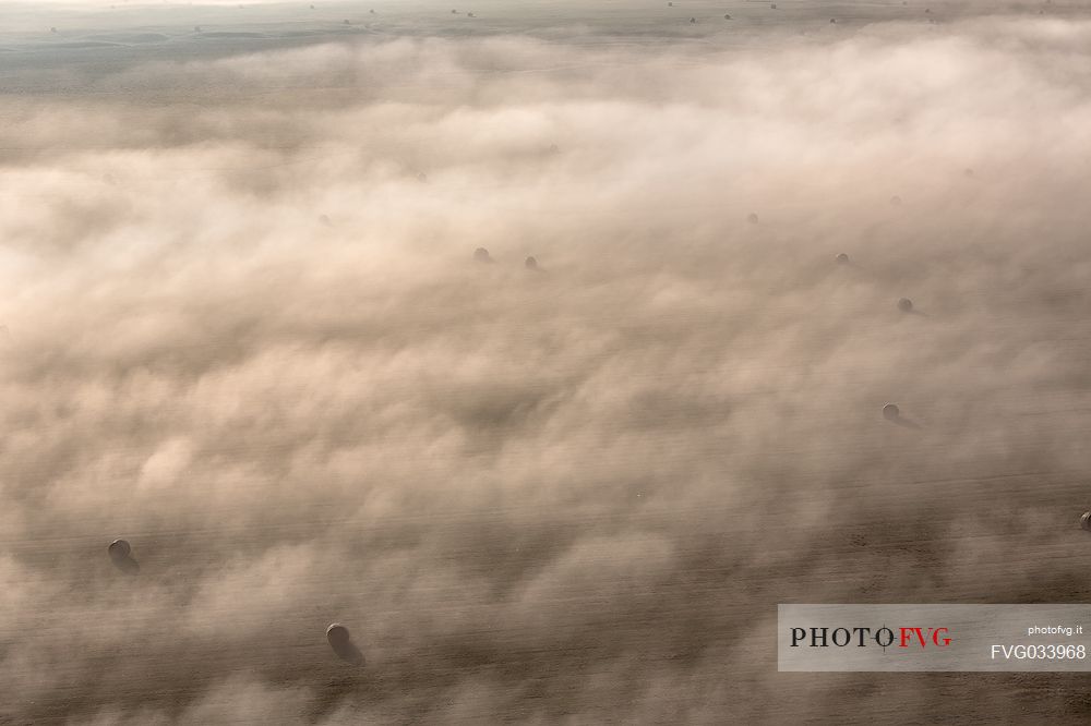 The fog on the plain alternates suggestive views in a slow decline, Castelluccio di Norcia, Sibillini National Park, Italy, Europe