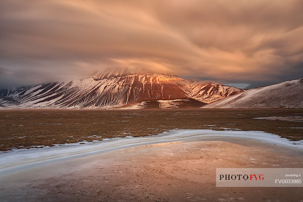 View of the Pian Grande of Castelluccio di Norcia, in the background the Vettore mountain at dawn, Sibillini National Park, Umbria, Italy, Europe