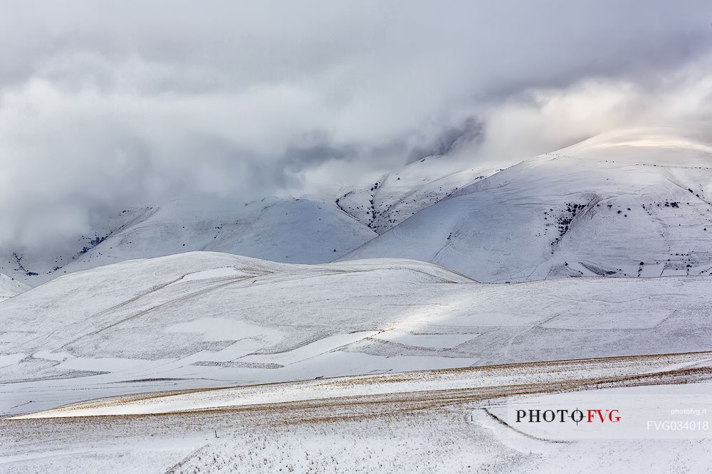 The snow covers the cultivated fields in Castelluccio di Norcia, Sibillini national park, Umbria, Italy, Europe