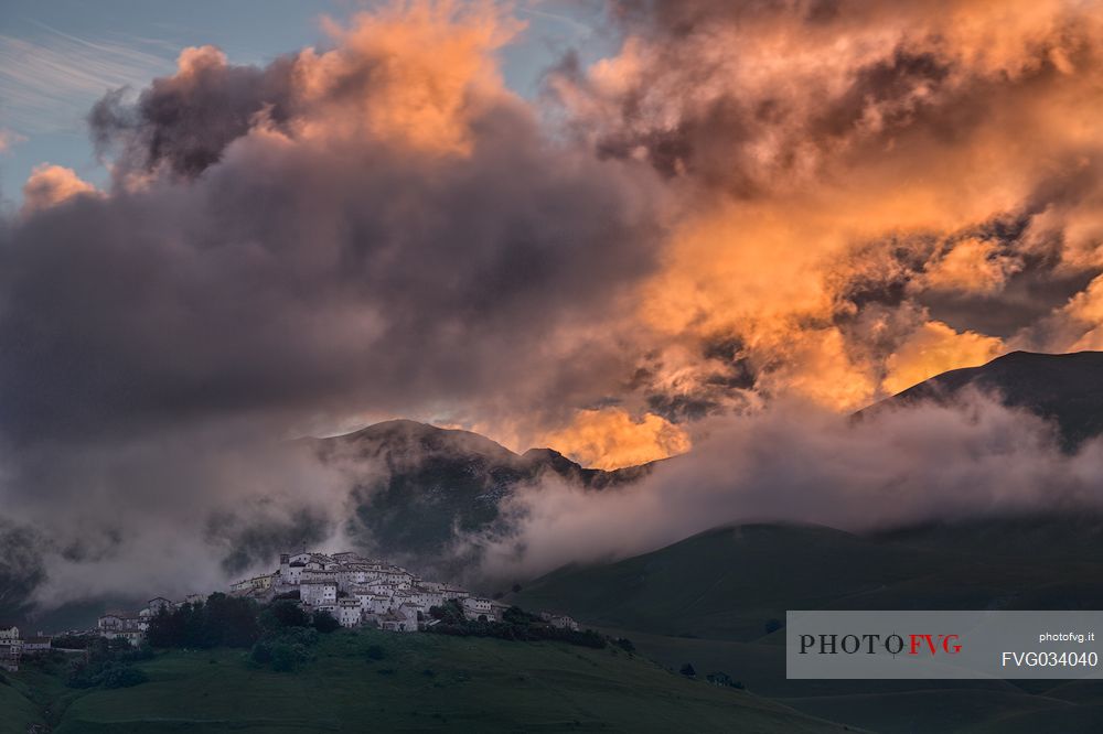 A dawn of fire over the village of Castelluccio di Norcia, Sibillini national park, Umbria, Italy, Europe