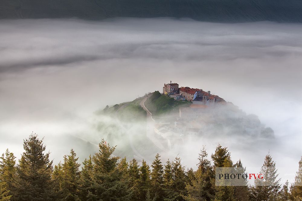 Castelluccio di Norcia village and the Pian Grande in the fog, Sibillini National park, Umbria, Italy, Europe