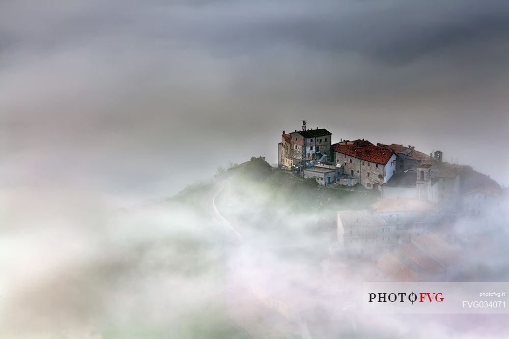 Castelluccio di Norcia village and the Pian Grande in the fog, Sibillini National park, Umbria, Italy, Europe