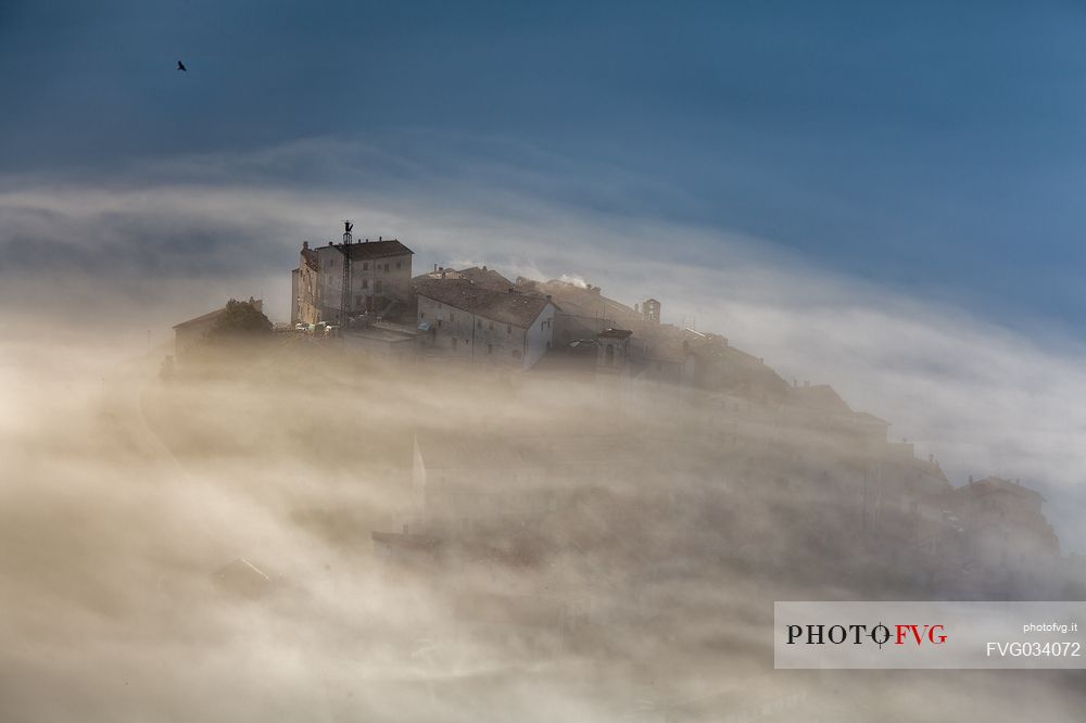 Castelluccio di Norcia village and the Pian Grande in the fog, Sibillini National park, Umbria, Italy, Europe