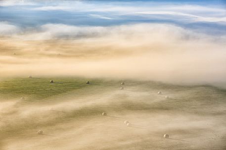 The fog on the plain alternates suggestive views in a slow decline, Castelluccio di Norcia, Sibillini National Park, Italy, Europe