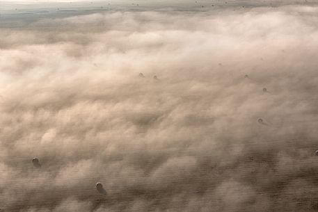 The fog on the plain alternates suggestive views in a slow decline, Castelluccio di Norcia, Sibillini National Park, Italy, Europe